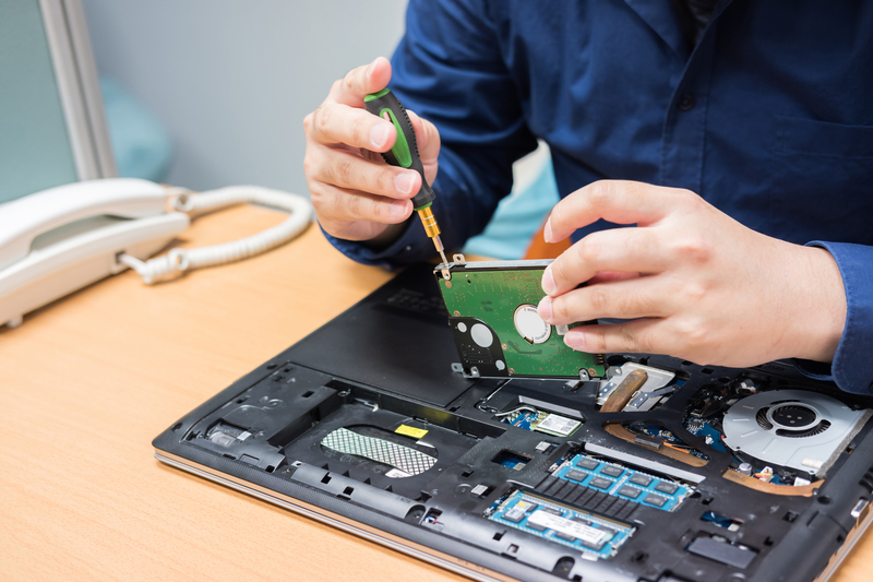 Technician support upgrade part and fixing laptop. select focus, Technician fixing laptop